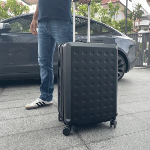 Man standing on a driveway with a TinySeats SeatCase next to him.